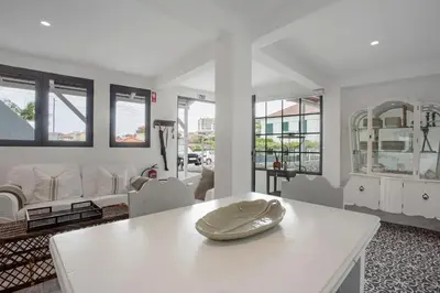 a living room with white furniture and a white table at The Village Loft in Caniço
