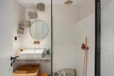 a bathroom with a sink and a mirror at The Village Loft in Caniço