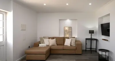 a living room with a couch and a tv at Franco's House II, Mar e Serra in Estreito da Calheta
