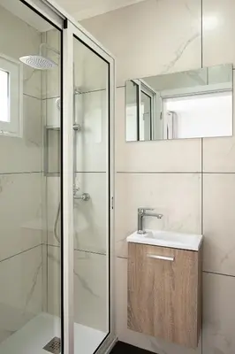 a bathroom with a sink and a shower at Franco's House II, Mar e Serra in Estreito da Calheta