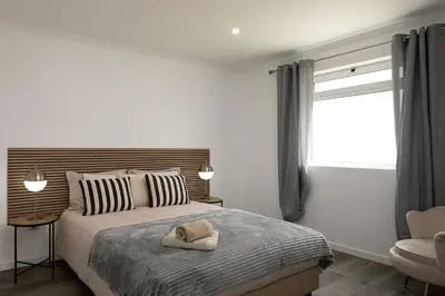 a bedroom with a bed with two towels on it at Franco's House II, Mar e Serra in Estreito da Calheta
