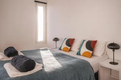 a bedroom with two beds and a couch at High View Apartment in Funchal