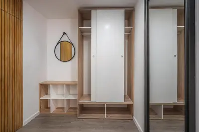 a dressing room with white cabinets and a mirror at High View Apartment in Funchal