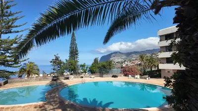 a swimming pool in a hotel with a view of the ocean at High View Apartment in Funchal
