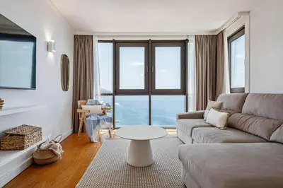 a living room with a couch and a table at Infinity View by Homie in Funchal