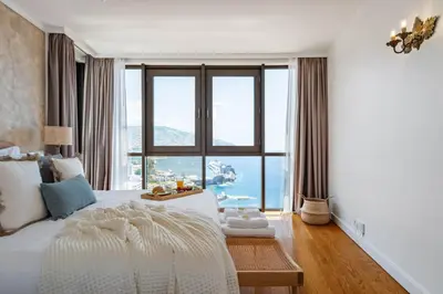 a bedroom with a large bed with a large window at Infinity View by Homie in Funchal