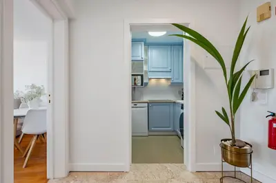 a kitchen with blue cabinets and a potted plant at Infinity View by Homie in Funchal