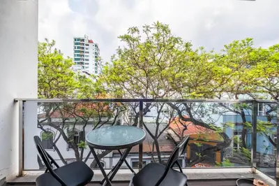 a glass table and chairs on a balcony with trees at Urban Stay 3A by Homie in Funchal