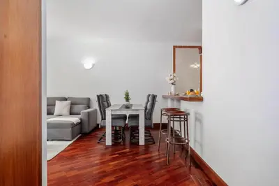 a living room with a table and chairs and a couch at Pestanas Nest by Homie in Ribeira Brava