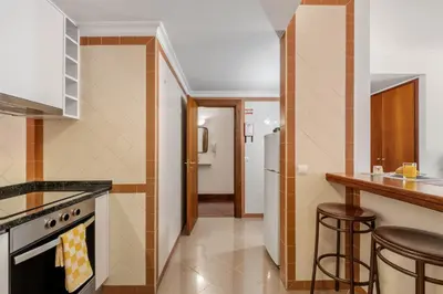 a kitchen with a stove and a refrigerator at Pestanas Nest by Homie in Ribeira Brava