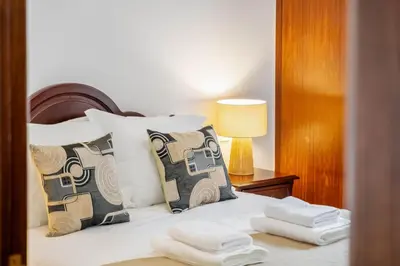a bedroom with a bed with two towels on it at Pestanas Nest by Homie in Ribeira Brava