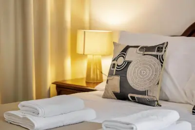 a hotel room with a bed with a pillow and towels at Pestanas Nest by Homie in Ribeira Brava