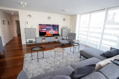 a living room with a couch and a flat screen tv at Plaza Residence in Funchal