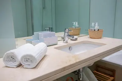 a bathroom counter with a sink and a mirror at Plaza Residence in Funchal