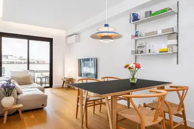 a dining room and living room with a table and chairs at Design Suite at Formosa Beach in Funchal