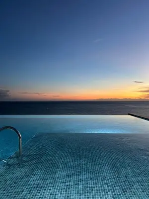 a swimming pool with a view of the ocean at Design Suite at Formosa Beach in Funchal