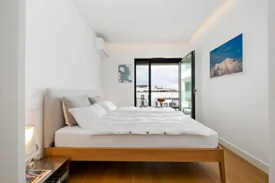 a bedroom with a bed and a window at Design Suite at Formosa Beach in Funchal