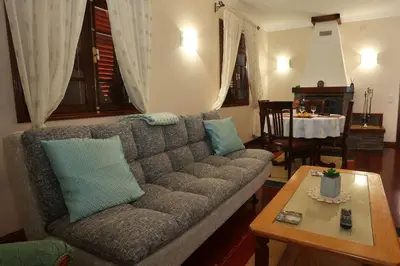 a living room with a couch and a table at Casa da Cascata in Santana