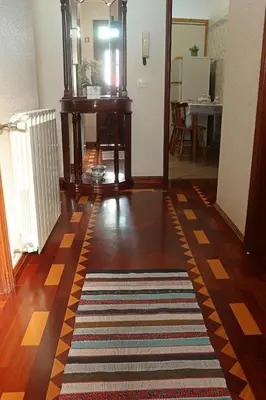 a hallway with a rug on a hard wood floor at Casa da Cascata in Santana