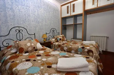 a bedroom with two beds with towels on them at Casa da Cascata in Santana