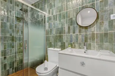 a bathroom with a sink and a toilet and a mirror at O Marinheiro 15A in Caniçal