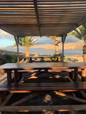 a wooden picnic table with a view of the desert at O Marinheiro 15A in Caniçal