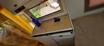 an overhead view of a kitchen with a window at Pauls caravan for 4 - See the horses from your bed in Barão de São João