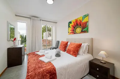 a bedroom with a large bed and a window at OurMadeira - Taberna Apartments in Funchal