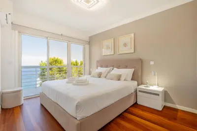 a bedroom with a large bed and a large window at Naval View By Links in Funchal