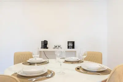 a dining table with glasses and plates and napkins at Naval View By Links in Funchal