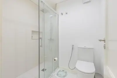 a bathroom with a toilet and a glass shower at Naval View By Links in Funchal