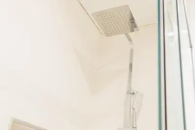 a shower with a shower head in a bathroom at Naval View By Links in Funchal