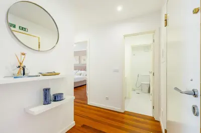a room with a mirror and a bathroom with a bed at Naval View By Links in Funchal