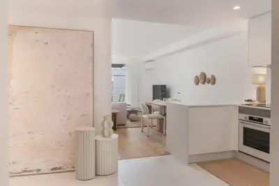 a kitchen with white walls and a sliding door at Acqua Residence VI by An Island Apart in Funchal