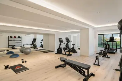 a gym with many exercise equipment in a room at Acqua Residence VI by An Island Apart in Funchal