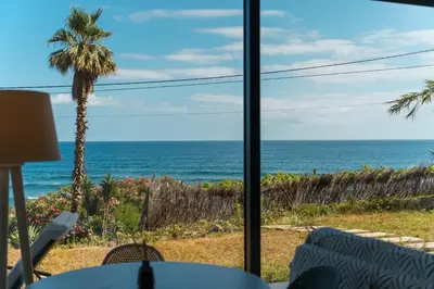 a view of the ocean from a restaurant window at GuestReady - Relax & Ride the Waves in São Vicente