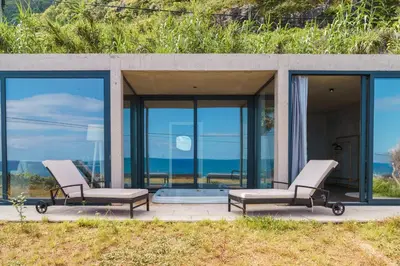 two chairs on a patio with the ocean in the background at GuestReady - Relax & Ride the Waves in São Vicente