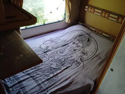 a drawing on a bed in the back of a room at Uljanas caravana for 2 with view of the rescued horses in Barão de São João