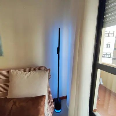 a lamp sitting next to a couch next to a window at Sol II in Funchal