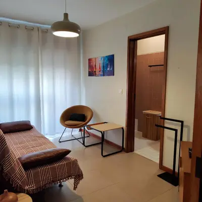 a living room with a couch and a chair at Sol II in Funchal