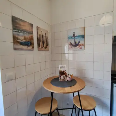 a small table with two stools in a kitchen at Sol II in Funchal