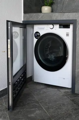 a white washing machine sitting next to a wall at Ocean Valley by Mth in Ribeira Brava