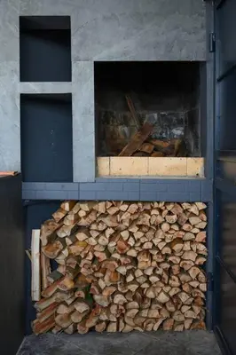 a pile of fire wood in an oven at Ocean Valley by Mth in Ribeira Brava