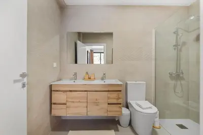 a bathroom with a sink and a toilet and a shower at Atlantic Pebble Villa in Ribeira Brava