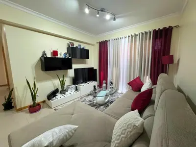 a living room with a couch and a tv at Funchal Cozy Private Room, Ensuite Bathroom, WiFi and Great Location in Funchal