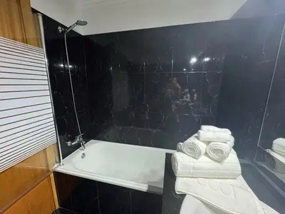 a table with two glasses and a bottle of wine and fruit at Funchal Cozy Private Room, Ensuite Bathroom, WiFi and Great Location in Funchal