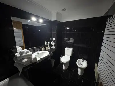 a living room with a couch and a glass table at Funchal Cozy Private Room, Ensuite Bathroom, WiFi and Great Location in Funchal