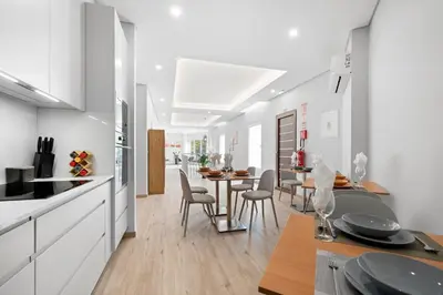 a kitchen and dining room with a table and chairs at North View Guesthouse in Senhora do Rosário
