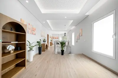 a hallway with white walls and a large window at North View Guesthouse in Senhora do Rosário