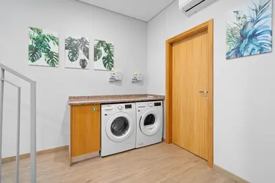 a laundry room with a washing machine in it at North View Guesthouse in Senhora do Rosário